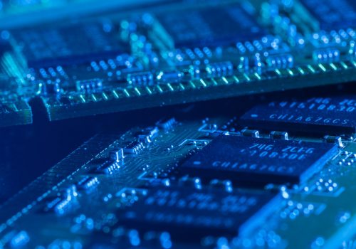 Closeup picture of some computer parts in blue light